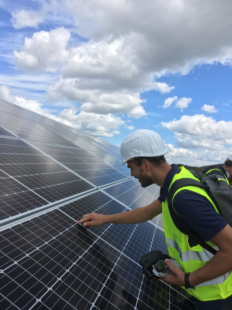 Employee takes a close look at solar panels